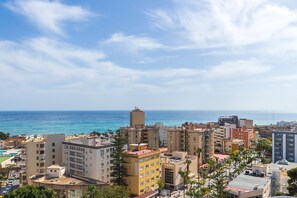 A coastal cityscape with high-rise buildings, a clear sky, and the ocean in the background. - Casa Dalias - Sea Views (Torremolinos)