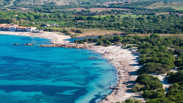 An aerial view of a coastal area with a beach, rocky shoreline, and surrounding greenery. - Onda Apartment Ac Wifi, Gallura (Portobello Di Gallura)