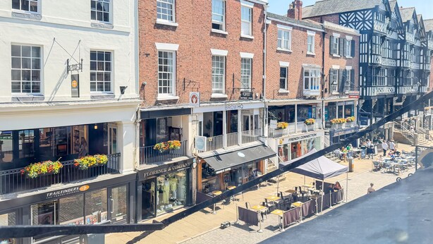 A row of shops with outdoor seating, including a coffee shop and a boutique. - Bridge Street Rows Apartment -  a house that sleeps 8 guests  in 3 bedrooms (Chester)