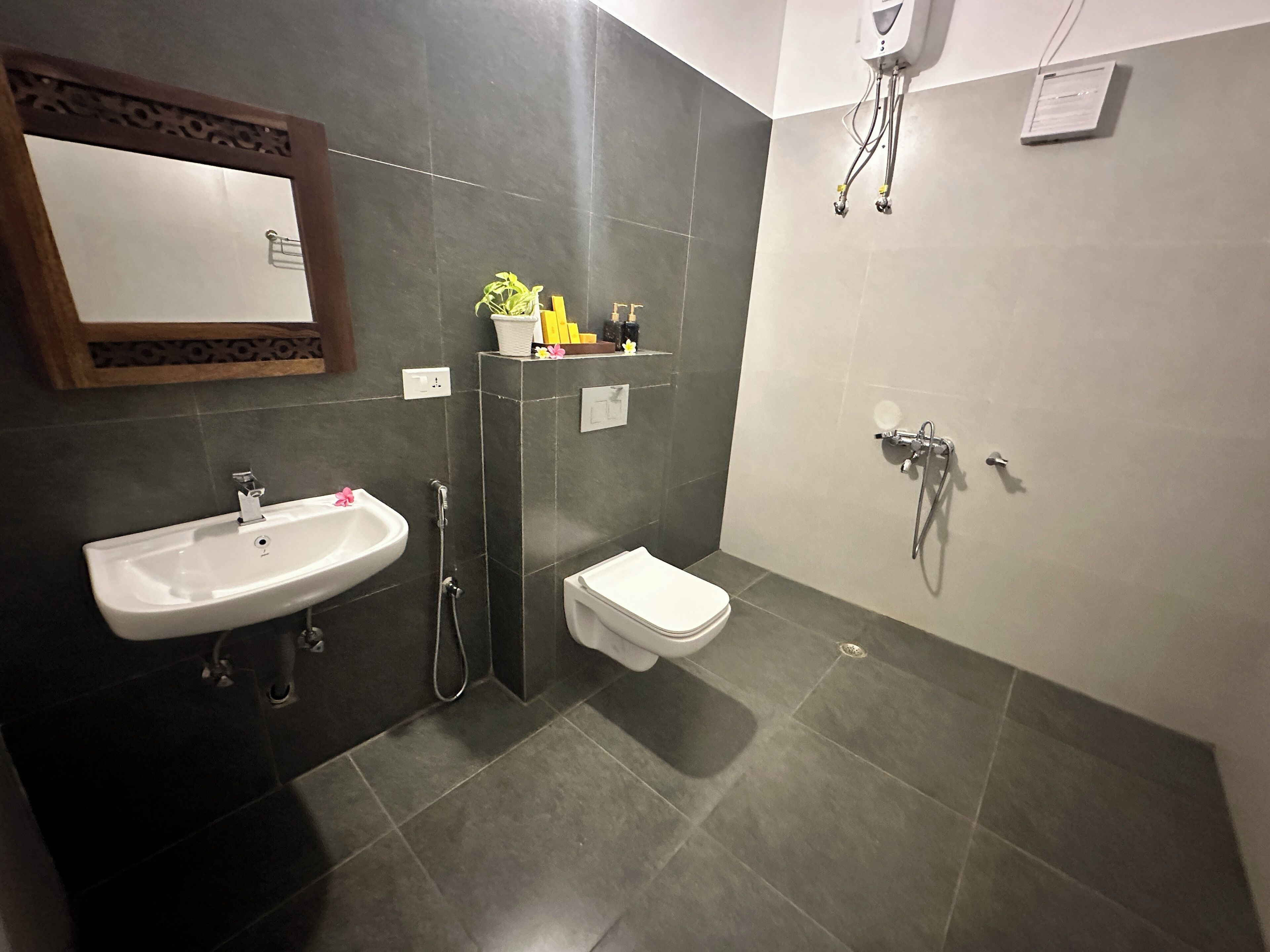A bathroom with a sink, toilet, and shower.