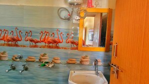 A bathroom with a sink, a mirror, and a water heater. - Shivlok Hotel  (Ukhimath)