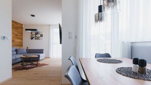 Un salon moderne comprenant un canapé, une table basse et un coin repas avec une table et des chaises en bois.