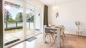 A dining area with a table, chairs, and a vase of flowers. - Cozy barrier-free apartment in central Vegesack/2-4 pers. (Bremen)