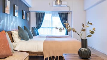 Deluxe Apartment, Balcony, City View | Living area | 50-inch flat-screen TV with cable channels