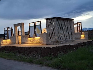 A modern building with a brick facade and large glass windows, surrounded by a landscaped area. - Apartment 1, Hill Costa Dei Trabocchi (Villalfonsina)
