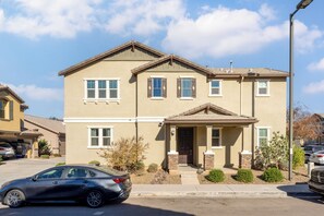 Two-story residence with a front entrance, porch, and shutters on each floor.