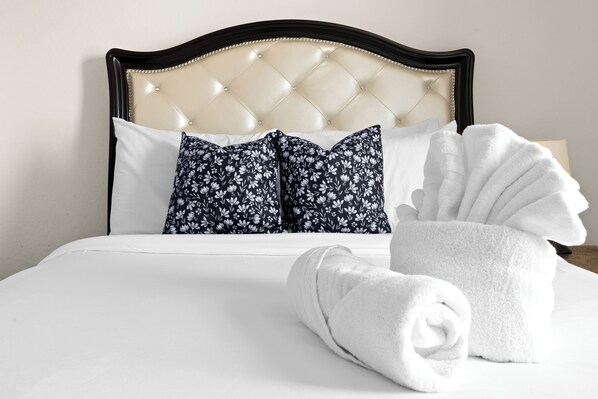 Restful retreat with a tufted headboard and plush pillows.