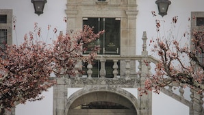 A historic building entrance with a stone archway, a balcony, and a staircase leading up. - MS Collection Arouca Mosteiro de Arouca (Arouca)