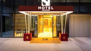 A hotel entrance with a modern design, featuring a prominent sign and a welcoming entrance. - Si Hotel  (Tirana)