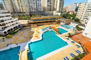 A rooftop pool area with multiple pools, sun loungers, and a Zoomarine restaurant. - Praia da Rocha/610/Clube P. Rocha/SunnyApart/by IG (Portimão)