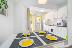 Enjoy a home away from home with a compact apartment featuring a dining area, kitchenette, and modern amenities.