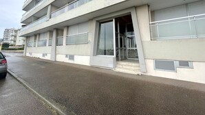 A multi-story building with balconies, large windows, and a visible entrance. - Seaside apartment with balcony, private parking in Les Sables-d'Olonne (Les Sables-d'Olonne)