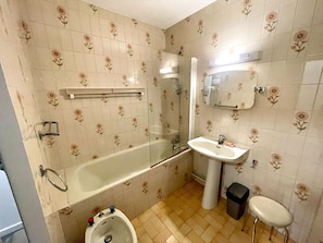 A bathroom with a bathtub, a sink, a toilet, and a shower.