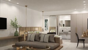 Un dormitorio moderno con sofá, mesitas de noche, televisor y baño con lavabo y espejo.