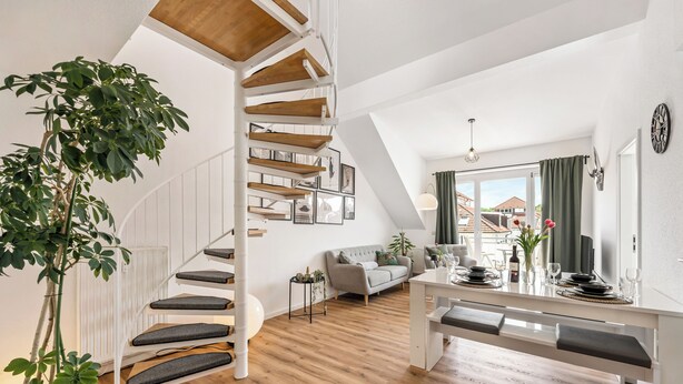 A modern interior with a wooden staircase, a dining area, and a living space. - Vacation apartment Hirschegg, 2 x bath 5Z 10 beds kitchen 2 parking spaces, WLAN (Bad Friedrichshall)