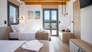 A modern bedroom with two beds, a wooden ceiling, a sliding glass door to a balcony, and a TV mounted on the wall. - Casa Galatas | Private pool |The Wisers Living (Chania)