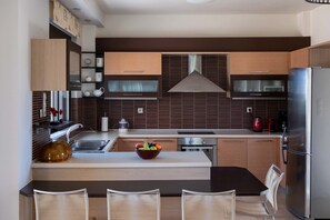 Fridge, coffee/tea maker, highchair, cookware/dishes/utensils