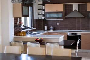 Fridge, coffee/tea maker, highchair, cookware/dishes/utensils