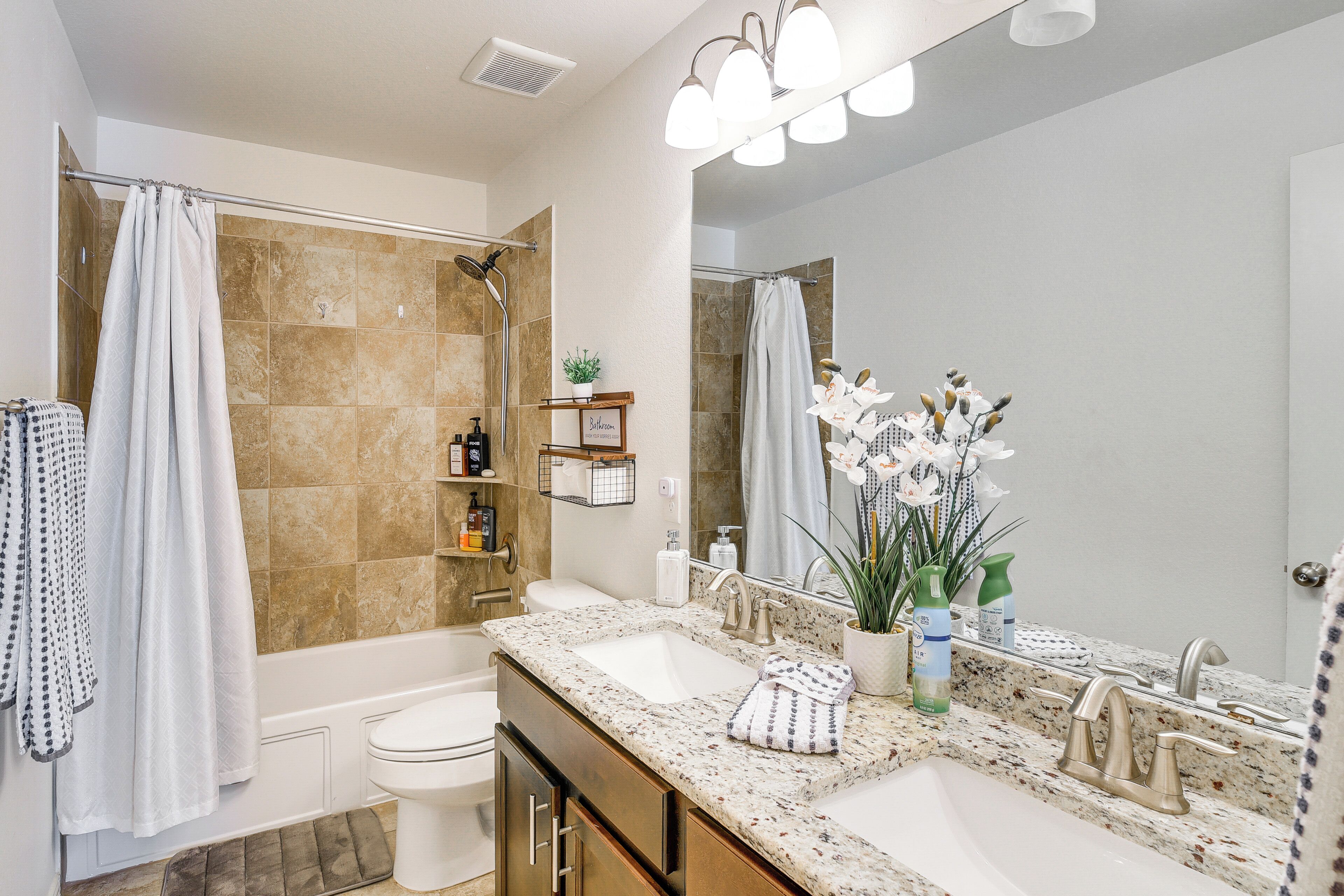 A bathroom with a bathtub, toilet, sink, and shower.
