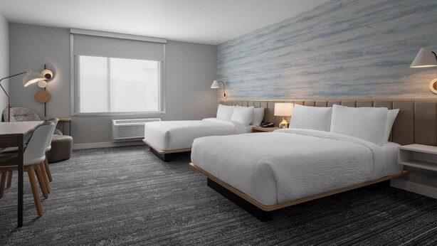 A hotel room with two beds, a desk, a chair, a window, and a wall with a textured design. - Towneplace Suites By Marriott Nampa (Nampa)