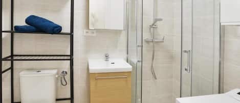 Shower, hair dryer, towels, toilet paper