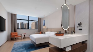 A modern hotel room with a large bed, a bathroom with a large mirror, a desk, and a view of the city. - Days Inn by Wyndham Hangzhou Gongshu (Hangzhou)