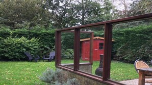 A brick wall with a window overlooking a garden. - Bungalow for 4 People in Wildrijk (Sint Maartensvlotbrug)