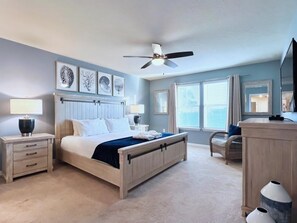 A bedroom with a bed, bedside tables, a ceiling fan, a dresser, a chair, and a large window with blinds. - Fabulous 5bd Family Townhome With Splash Pool-726g 5 Bedroom Townhouse (Davenport)