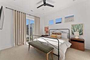 A bedroom with a bed, bedside table, lamp, bench, and a ceiling fan. - Villa #11 Adventure Retreat At Bloomington Villas 4 Bedroom Townhouse (St. George)