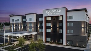 A modern hotel with a prominent sign reading "Homewood Suites by Hilton". - Homewood Suites by Hilton Jackson (Jackson)