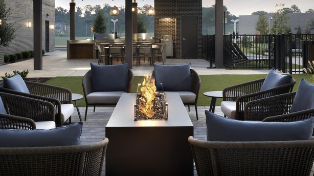 A patio area with outdoor seating, a fire feature, and a kitchen area. - Homewood Suites by Hilton Jackson (Jackson)