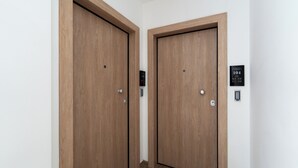 Two wooden doors with a digital lock and a keypad on the wall. - Athens luxury suite 26 m2  (Athina)