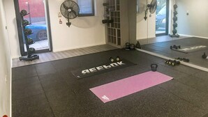 A gym with a mirrored wall, exercise equipment, and a mat with 'AFFLEK' written on it. - For Students Only Central Pl Sheffield (Sheffield)