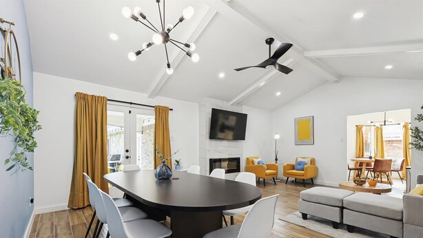 A modern living room with a dining area, a fireplace, and a ceiling fan. - Best of Desoto 4BR,3BA with Pool, HotTub, Cinema (DeSoto)