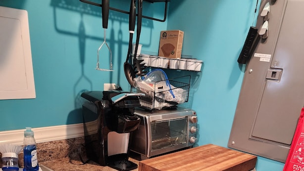 Cocina con encimera de granito, pileta de acero inoxidable y horno tostador.