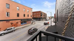 A street view with buildings, a 'Café' sign, and a 'STOP' sign. - Welcome to Black Palace-D! A beautiful downtown loft with easy access to everyth (Springfield)