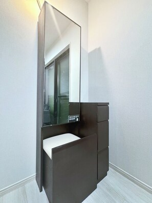 A compact, modern bathroom with a built-in mirror, a small sink, and a dark-colored vanity. - NEW! [Built in 2024, Entire Newly Built House for Rent / Free Parking Available] Experience Osaka’s Old Town! Conveniently located just 8 minutes by train from Namba! Excellent access to Osaka, Kyoto, and Nara! (大阪市)