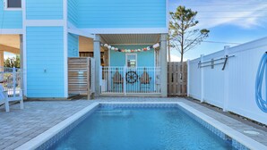 A swimming pool with a tiled edge, a wooden deck, and a white fence. - 🌊Dog Friendly Home with Private Pool-Steps to the Beach-Salty Owl🌊 (Cape San Blas)