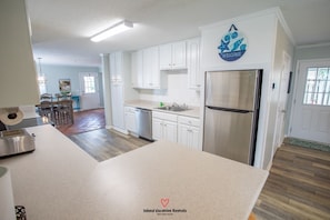 Enjoy cooking in this well-equipped kitchen with a refrigerator, dishwasher, and sink.