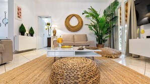 A modern living room with a sofa, coffee table, and a large woven ottoman. - Villa Grande Casa with Pool, Villa Grande Casa with Swimming Pool (Corfu)