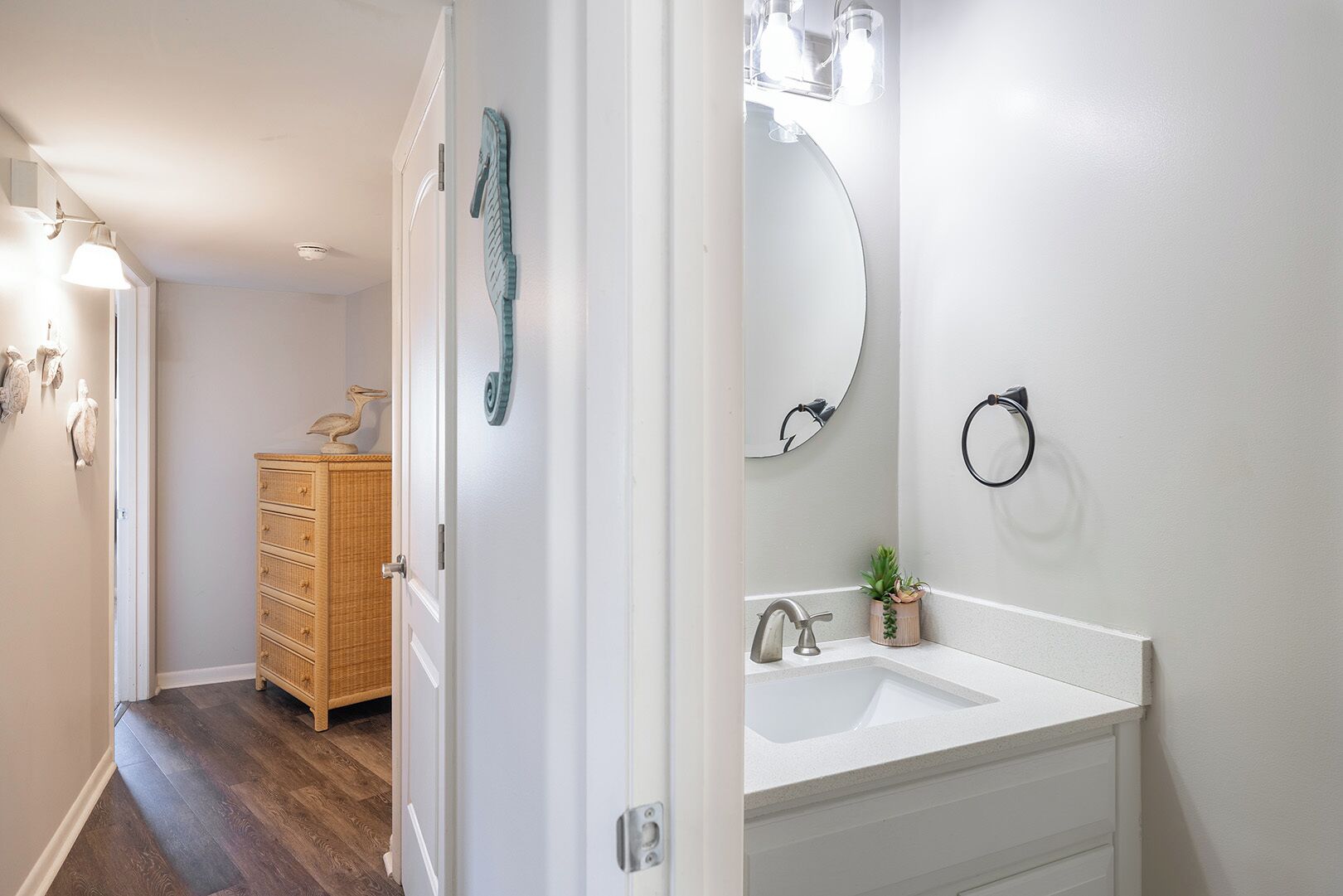 A bathroom with a white sink, a mirror, and a wooden cabinet.