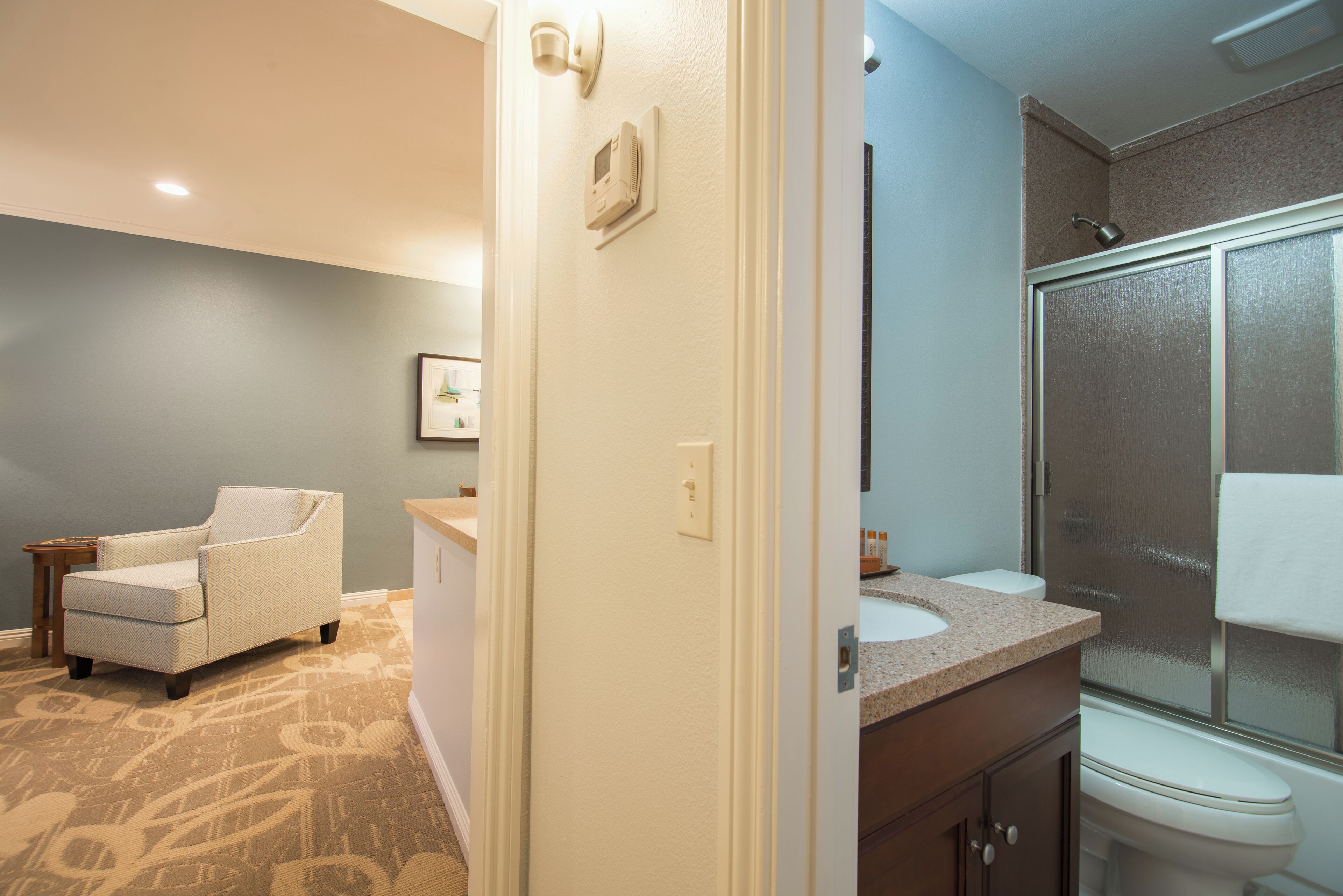A bathroom with a shower, toilet, and sink.