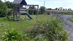 A playground with a slide and climbing structures. - L'étape conviviale gîte 2 for 6 people (Guitté)