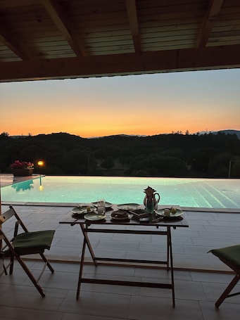 Outdoor dining. Stone house with private infinity pool in the middle of the oasis