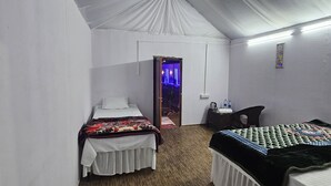 A tented room with two beds, a desk, and a chair. - The Mahakumbh Vatika (Karchana)