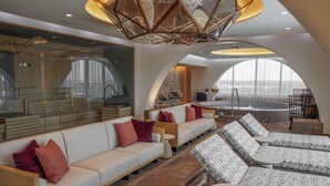 A modern lounge area with a sofa, lounge chairs, and a pool table. - Wind Creek Southland Casino and Hotel (Hazel Crest)