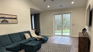 A modern living room with a sectional sofa, a small wooden table, and a patterned rug. - Nice house in Tellico village close to lake and golf course  (Loudon)