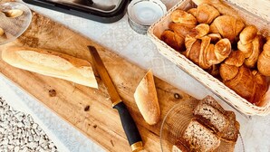 A buffet setup with various food items, a toaster, and a knife on a wooden board. - Ideal for friends: "La Belle Dame sans Regrets" with swimming pool, garden & workshop  (Talairan)