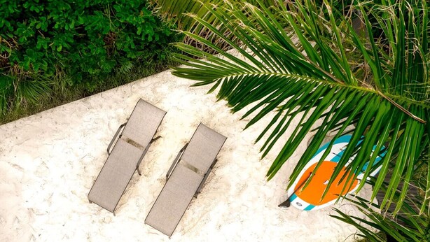 A sandy area with two sun loungers and a beach ball. - `The Morning Star` w/ spa & Private Mini Beach (Naples)