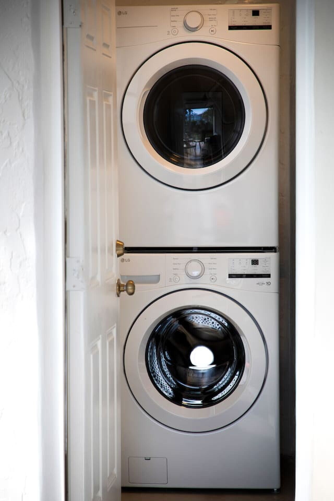 A laundry room with two stacked front-loading washing machines.